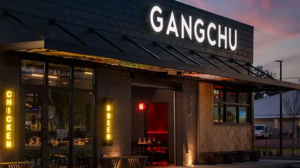 exterior of a restaurant with a white neon sign over the front entrance