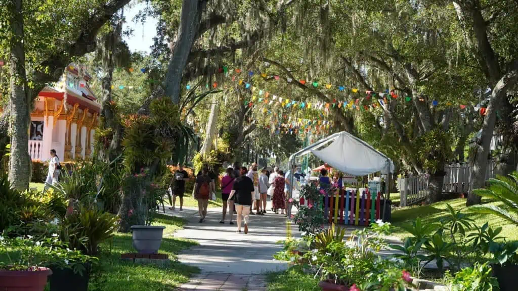 a market with multiple vendors outside a Buddhist Tampa