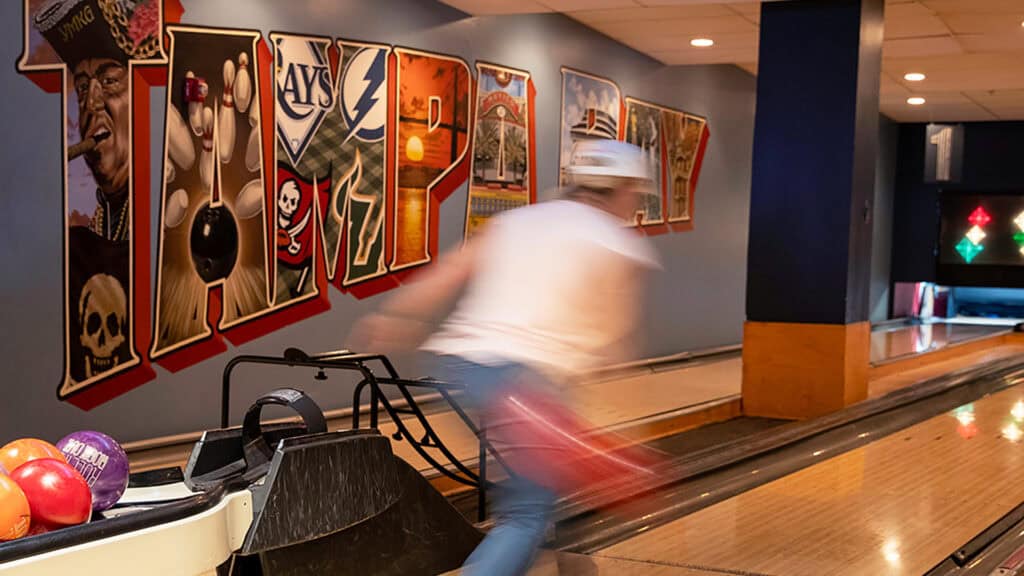 a person bowls at 10 pin lanes 