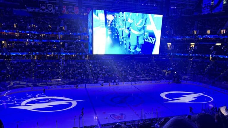 blue lights and lightning bolts projected on an ice rink