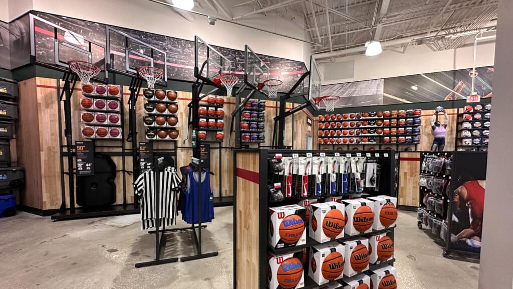 rows of basketballs and basketball hoops on display