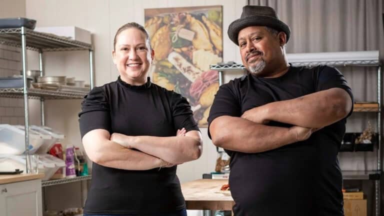 two people posing in a kitchen