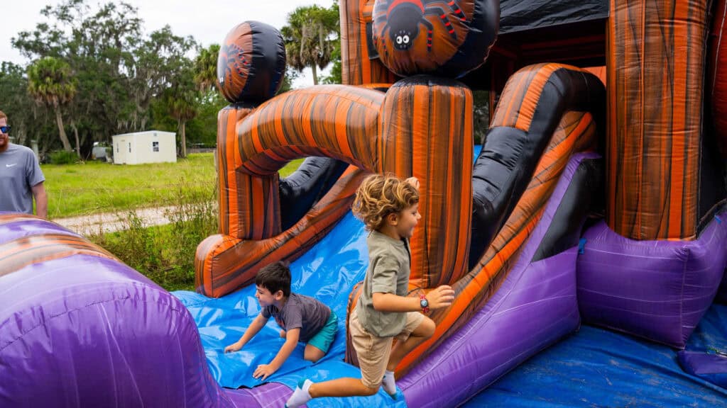 children enjoy a moon bounce