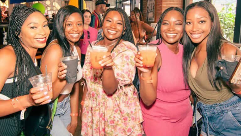 A group of people enjoy beverages during a festival