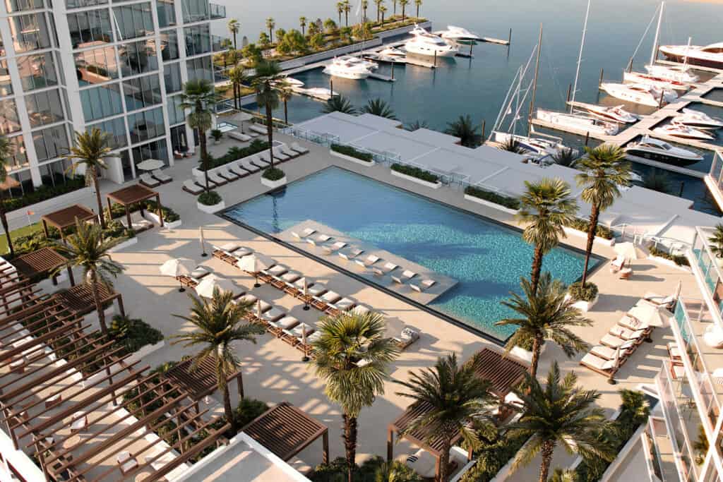 aerial rendering of a condo tower with a pool 