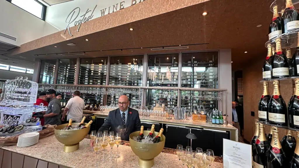 interior of a restaurant with a sommelier pouring drinks next to a champagne tower