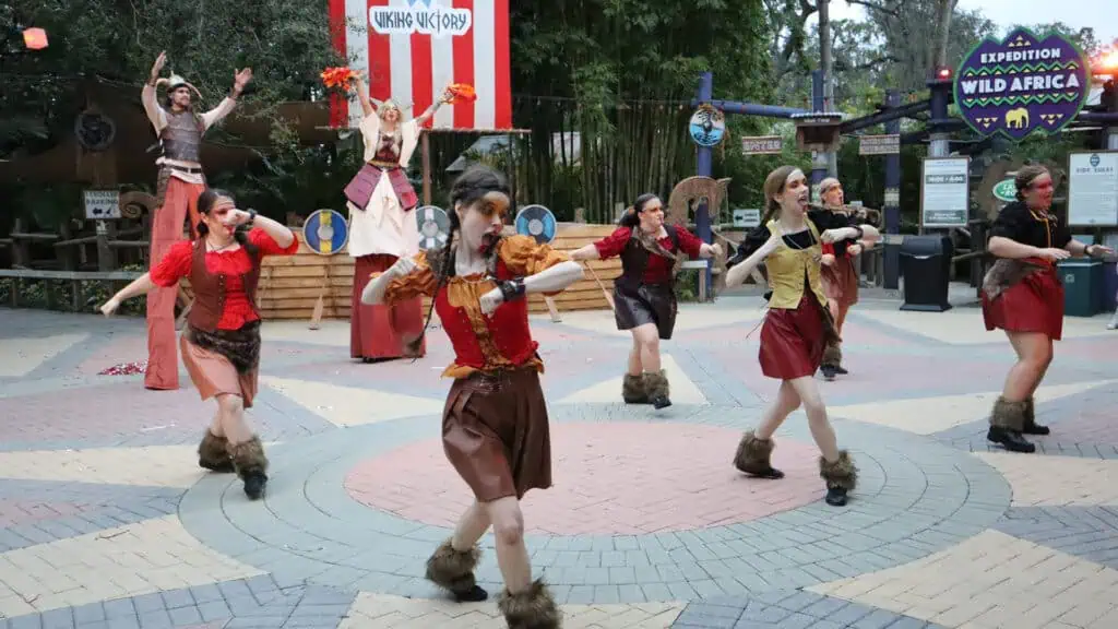 a group of performers at a zoo during a Halloween celebration