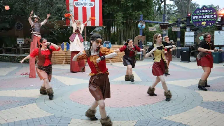 a group of performers at a zoo during a Halloween celebration