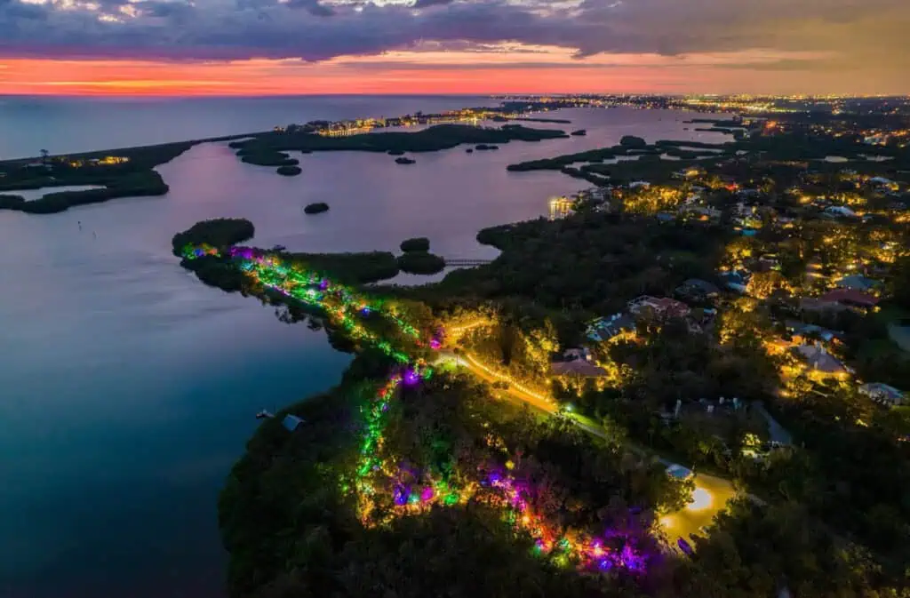 aerial view of a waterfront park with colorful lights