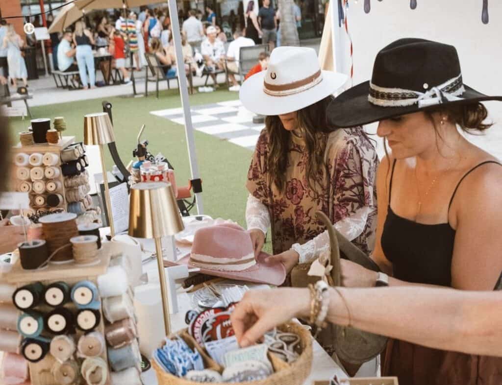 two people crafting custom hats at a hat bar