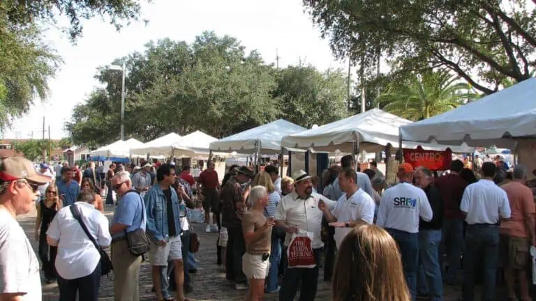 a group of people outside at a vendor festival.