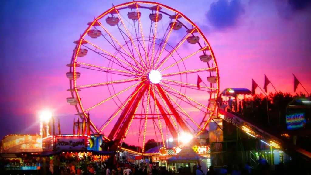 a large ferris wheel at sunset