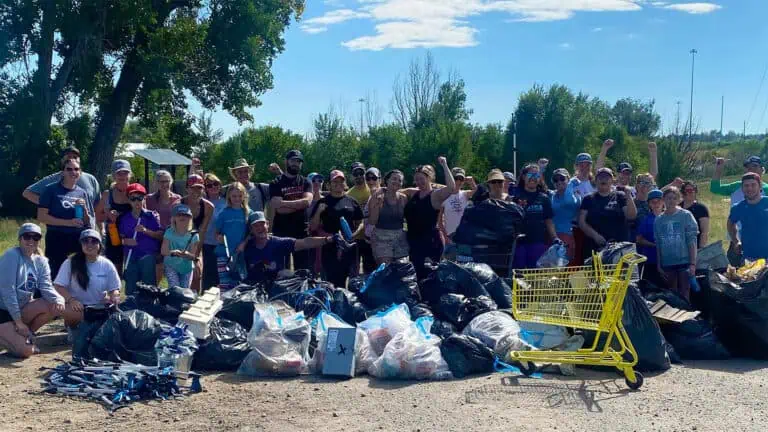 a group of people pose after completing a cleanup