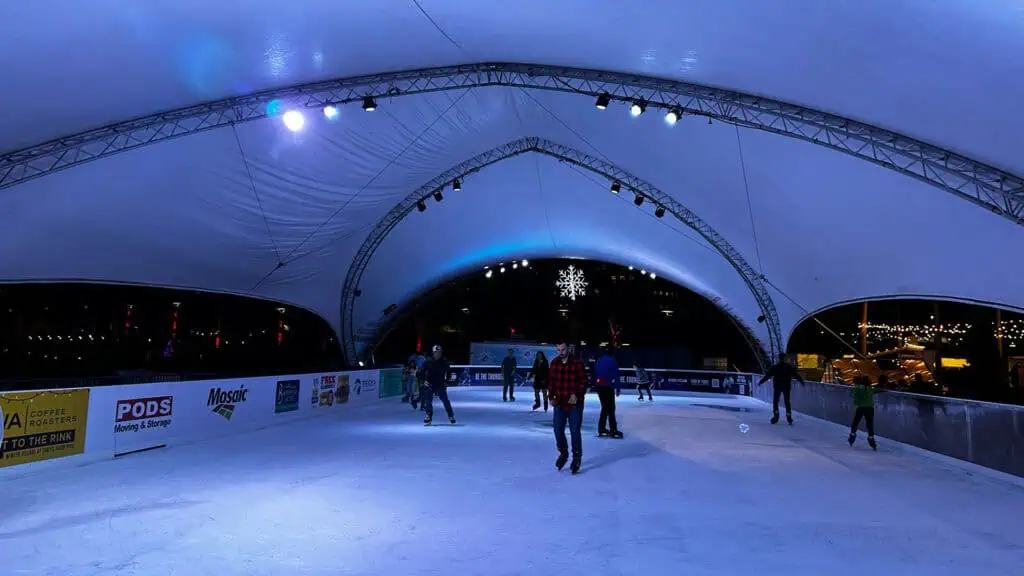 people ice skating at an outdoor rink 