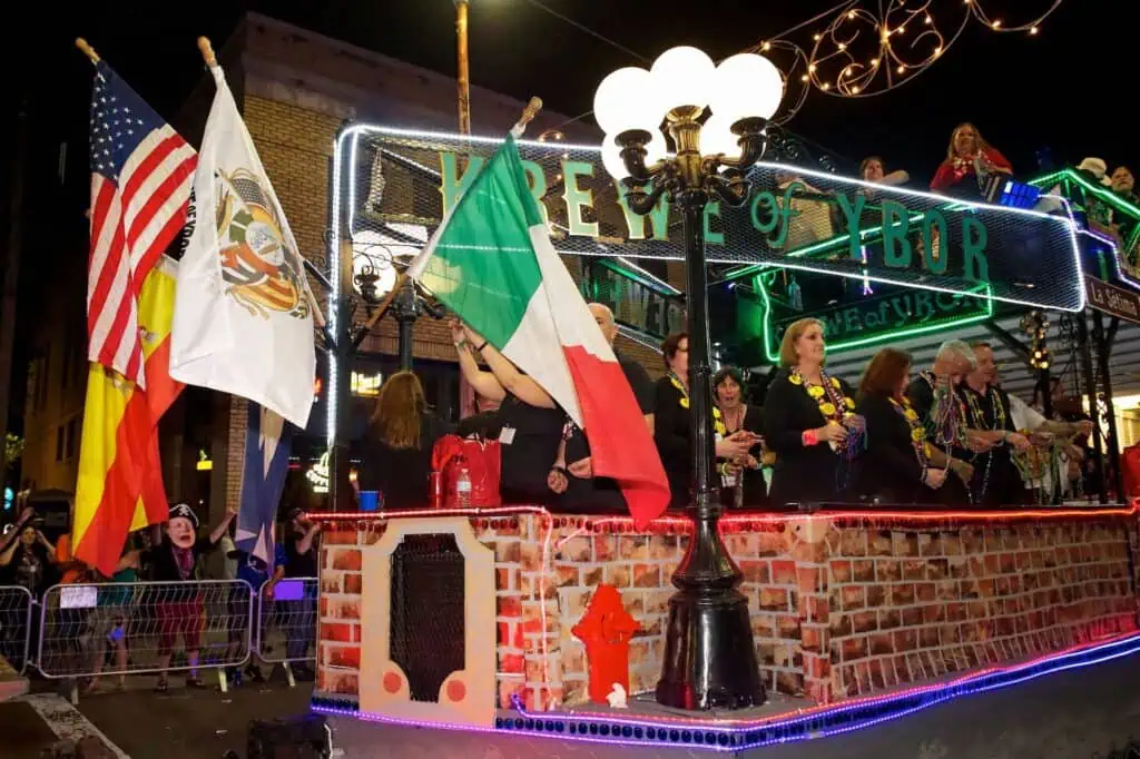 a group of people in a parade on a float shaped like a boat