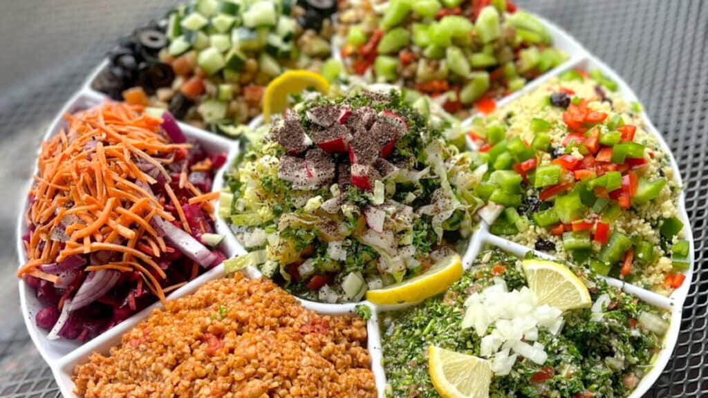 a plate of food with colorful dipping sauces