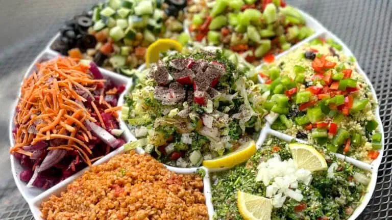 a plate of food with colorful dipping sauces