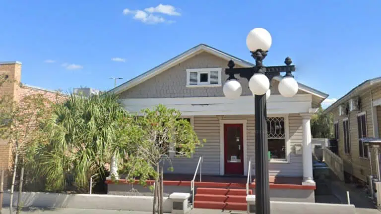 exterior of a wood house house with a street lamp out front