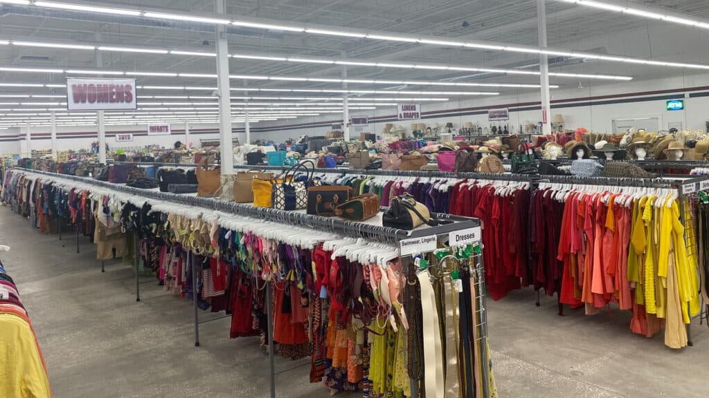 interior of a thrift shop wit horns of clothes available 