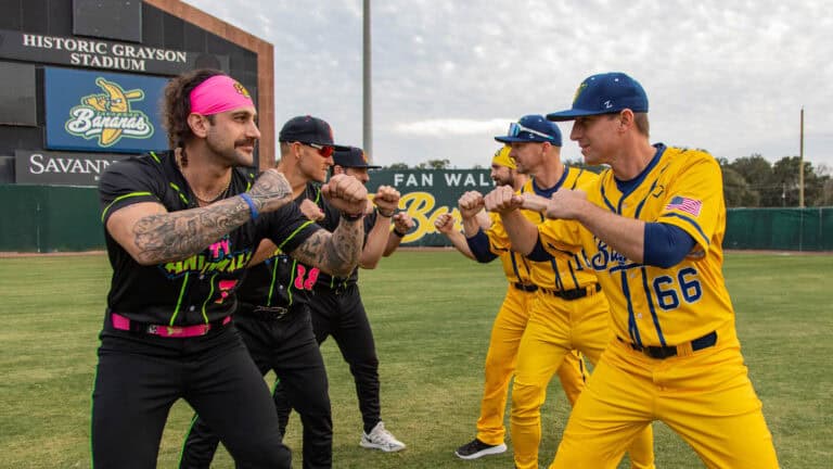 a group of baseball players on the field face off