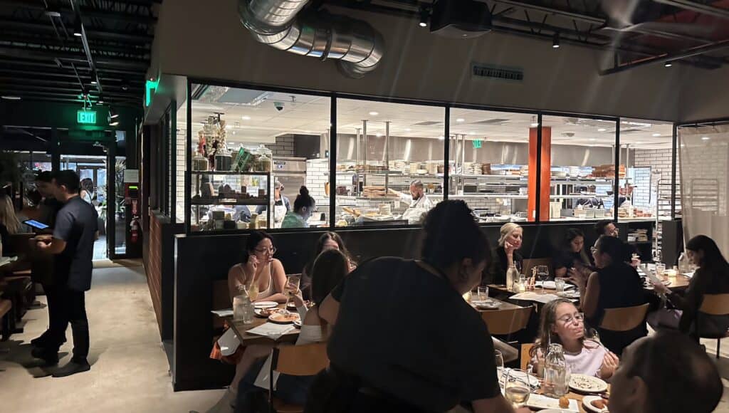 an open kitchen concept with a clear window to the staff working