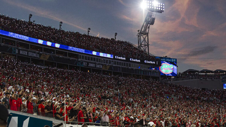 thousands of a fans in attendance at a football stadium