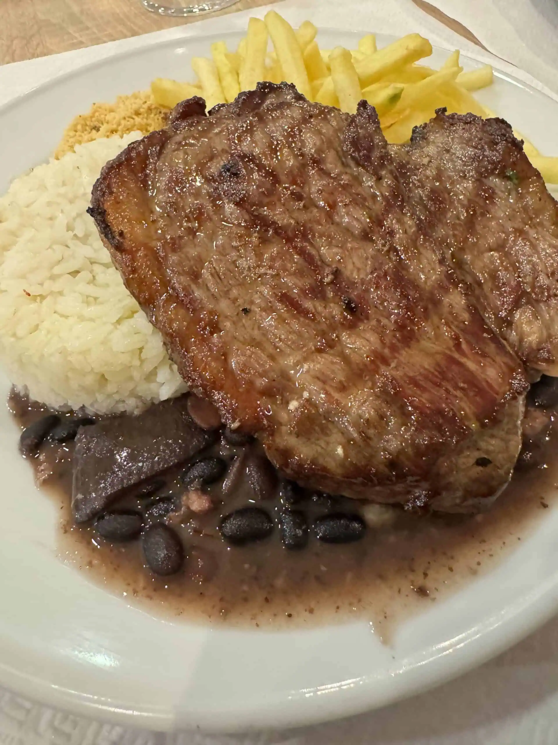 BellaBraga steak, black beans, white rice and french fries