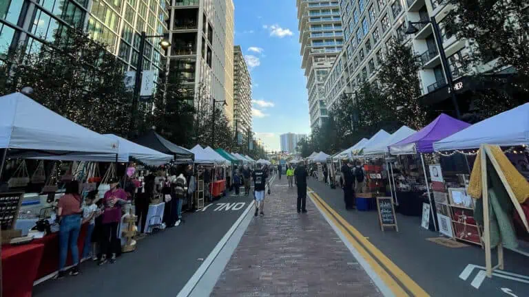 people walking through an open air market