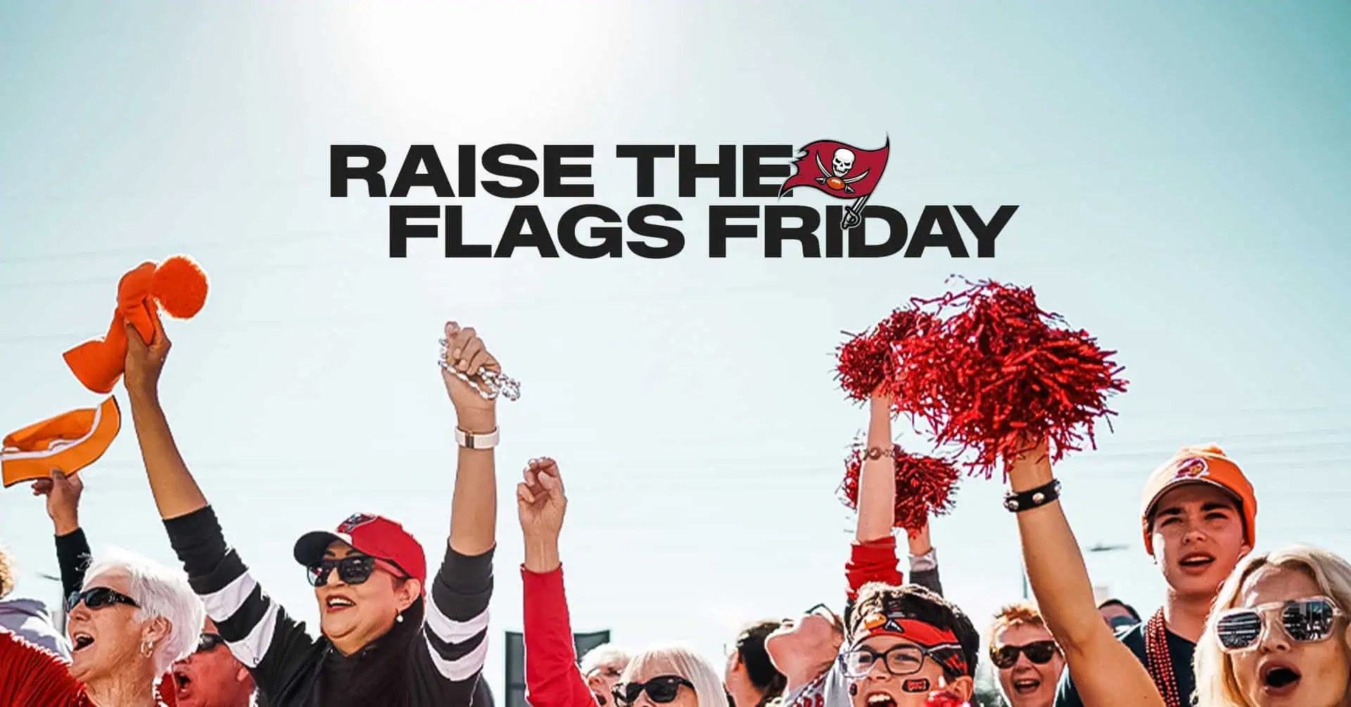 Fans cheer and wave pom-poms at a "Raise the Flags Friday" event, celebrating the Tampa Bay Buccaneers.