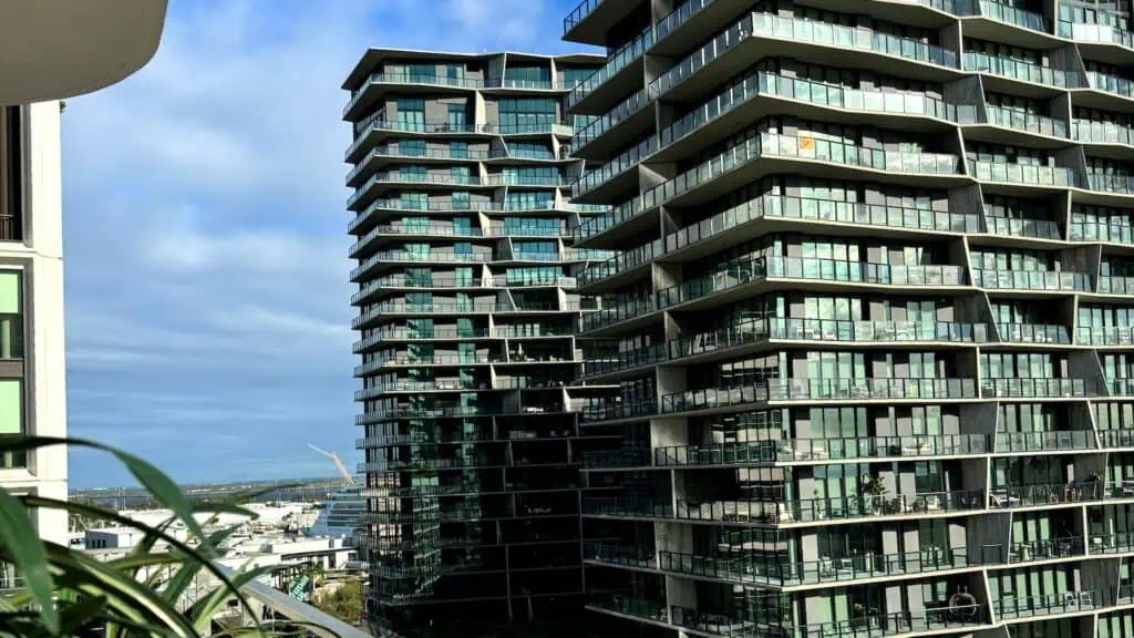 a rooftop view of two tall buildings and downtown area