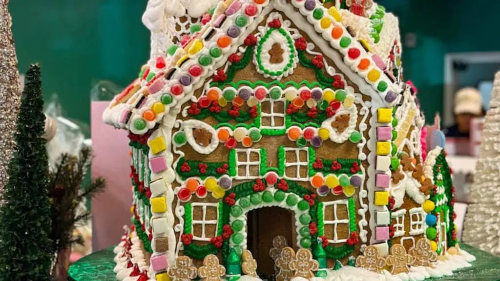 a large gingerbread house on display inside of a bakery