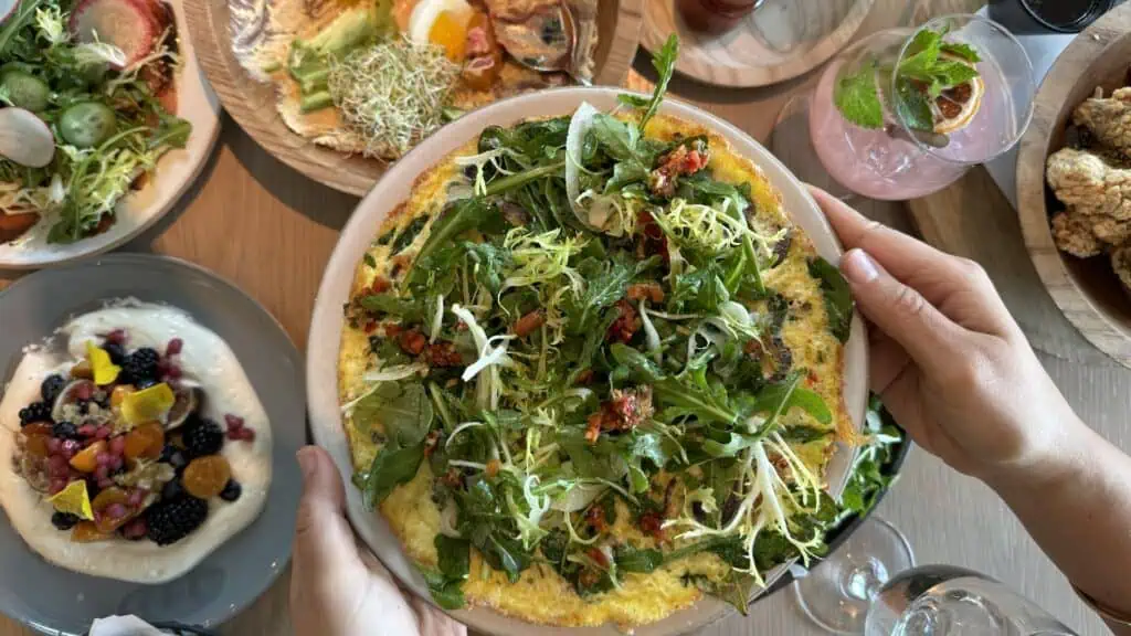 an omelette filled with fresh veggies on a plate