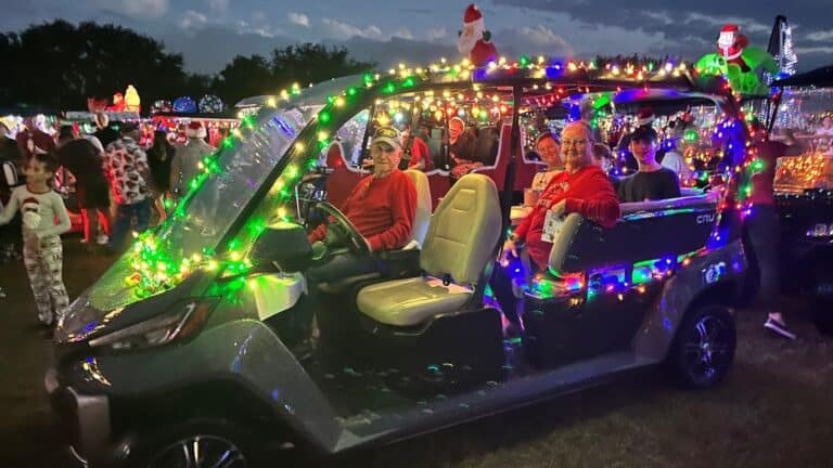 a golf cart decked out in colorful Christmas lights