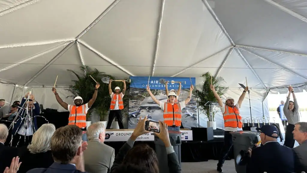 a group of people in construction outfits dancing on stage 