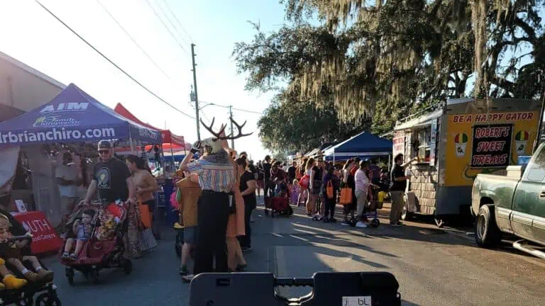 an open-air market with multiple vendors on either side of the street