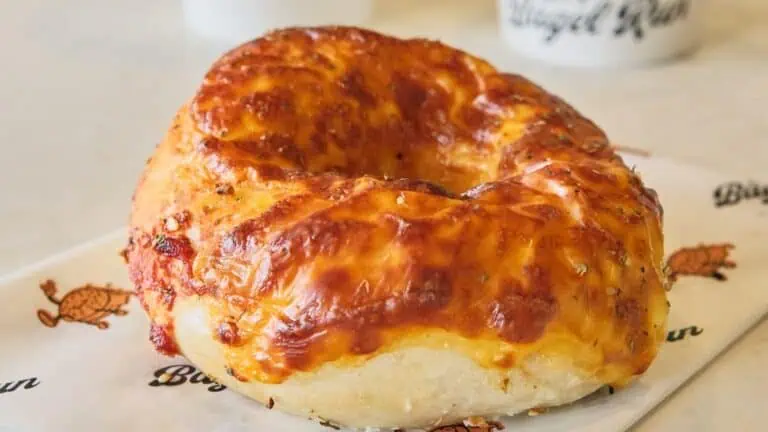 a bagel covered in melted cheese and red sauce