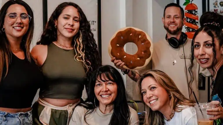 a group of people enjoy a DJ set inside of a cafe