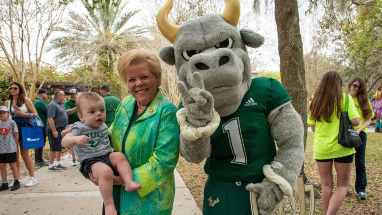 USF Bulls mascot next to a woman and a baby