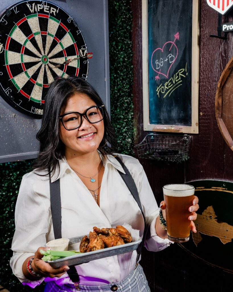 A person eating wings at Blind Goat in Tampa
