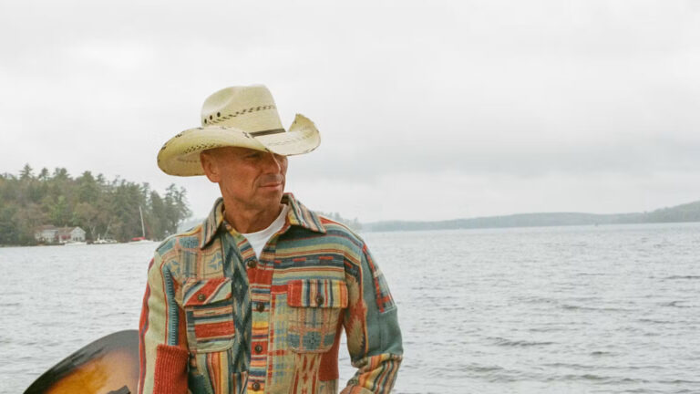 Kenny Chesney, who has an upcoming concert in Tampa, holding a guitar